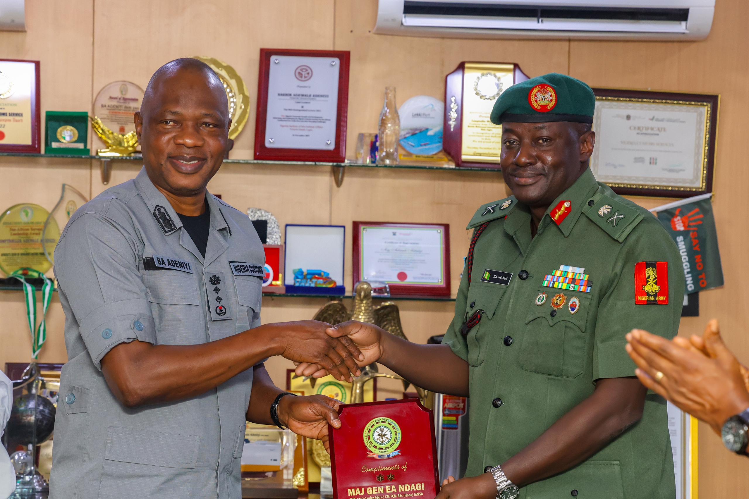 ...As CGC Adeniyi Declares NCS' Commitment to Partner with Defence Research and Development Bureau By Muhammad Bashir The Nigeria Customs Service (NCS), on Tuesday, 30 July 2024, declared its intentions to strengthen its partnership with the Defence Research and Development Bureau (DRDB) and intensify the formidable security presence at borderlines across the federation. This was made known by the Comptroller-General of Customs, Bashir Adewale Adeniyi, at his office when he received the delegation of the Bureau, led by the Director-General of DRDB, Major General Emmanuel Ndagi, who was at the Service's Headquarters to seek the CGC's partnership on delicate matters relating to national security. Continuing his speech, CGC Adeniyi expressed the readiness of the NCS to partner with the Bureau to sustain the Service's commitment to leveraging technological advancements in its operations, which, according to him, will result in achieving economic growth. However, the Comptroller-General of Customs said, "I see a lot of possibilities that will continue to evolve between the Nigeria Customs Service and DRDB in the area of technology because we live in the age of technology now." He added, "We believe that any organisation that ignores research and developments might be digging its own grave because, for us, the Nigeria Customs Service, the rapid change and dynamic nature of our environment presupposes the need for us to engage in technological development programmes constantly." "One of the immediate things suggested for us was using geospatial intelligence to combat the scourge of border crimes. We have also set up a structure devoted to our special intelligence. Beyond that, we have a Command and Staff College, where we engage our students in periodic research and operations." While speaking, the Director-General DRDB, Major General Emmanuel Ndagi, said their visit to the Customs House was to acquaint the CGC with the Bureau’s activities and to seek partnership with the Service as an essential security structure in the country. The DG, who identified some key areas on which the DRDB wishes to collaborate with the Nigeria Customs Service, also expressed optimism that their alliance will enable them to coordinate significant operations at border areas across the federation. The DG further stated, "Addressing these challenges with compassion and jointly developing technologies that address border security concerns will help us to fortify our border areas, and that is one key aspect that I want to seek the cooperation of the Comptroller-General of Customs to join hands with DRDB in partnership."